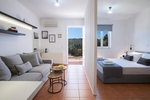 a bedroom and living room with a bed and a couch at Skyview Suites in Lefkada