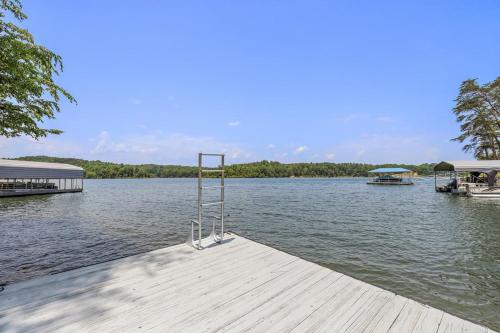 a dock with a metal object on the water at Heron Hideaway in Wilkesboro