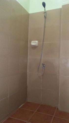 a shower with a shower head in a bathroom at Dweller's Pensione in Iloilo City