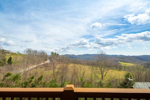 a view of a field and mountains from a porch at Serenity in Blowing Rock