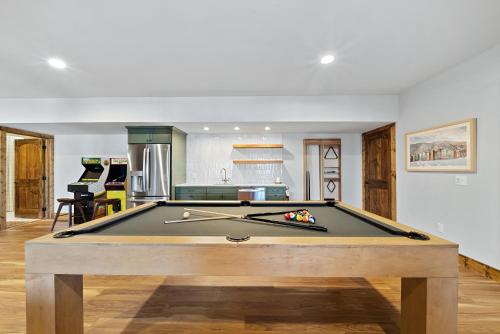 a pool table in the middle of a living room at Alpine Retreat in Seven Devils