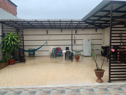 a patio with a table and chairs in a garage at Acacias home in Acacías