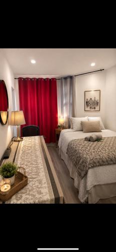 a bedroom with two beds and a red curtain at Uottawa Private Room Meters away from Parliament Hill in Ottawa