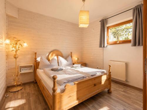 a bedroom with a wooden bed in a room at Ferienwohnung Feichten in Westendorf