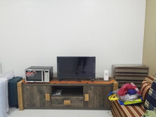 a tv sitting on top of a wooden entertainment center at Wind Residences in Tagaytay