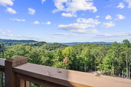 a wooden deck with a view of the forest at Majestic Meadows in Boone