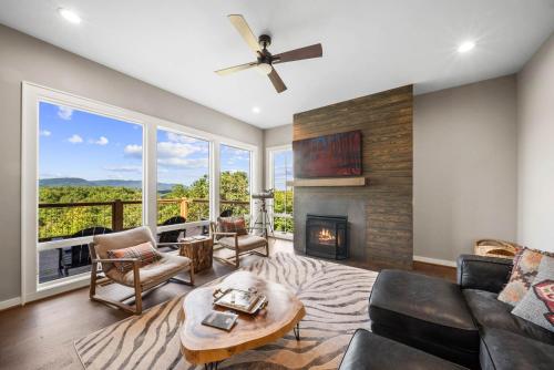 a living room with a couch and a fireplace at Majestic Meadows in Boone