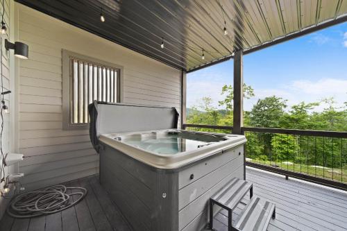 a hot tub on the deck of a house at Luxury Trails Escape in Boone