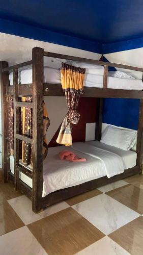 two bunk beds in a room with a window at Mekong Backpackers in Pakbeng