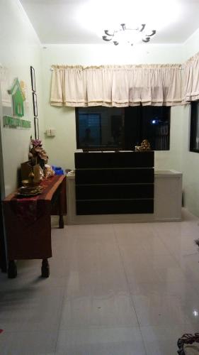 a living room with a dresser and a window at Dweller's Pensione in Iloilo City