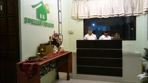two chefs in the window of a restaurant at Dweller's Pensione in Iloilo City