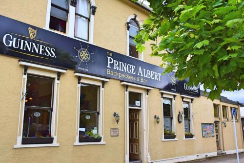 a building with a sign on the side of it at The Prince Albert Backpackers & Bar in Nelson
