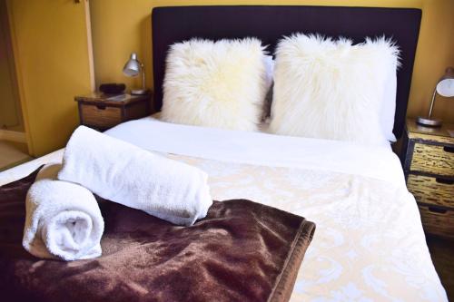 a hotel room with a bed with towels on it at The Prince Albert Backpackers & Bar in Nelson