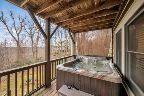 a hot tub on the balcony of a house at Appalachian Breeze in Blowing Rock