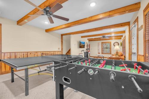 a ping pong table in a room with a ceiling fan at Appalachian Breeze in Blowing Rock