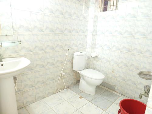 a bathroom with a toilet and a sink at Royal Palace in Dhaka