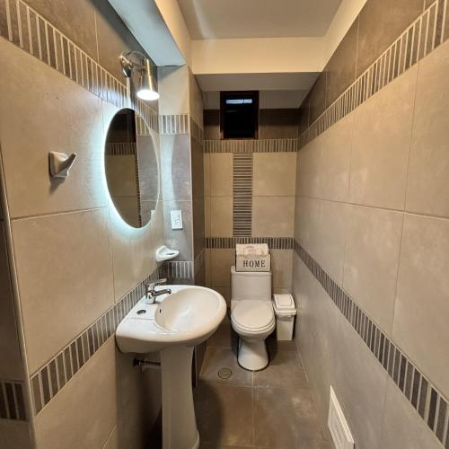 a small bathroom with a toilet and a sink at Hotel Inkalma Santa Marta in Arequipa