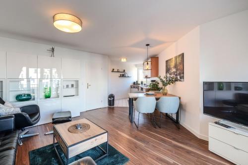 a living room with a couch and a table at Marina Hafenblick 321 in Cuxhaven