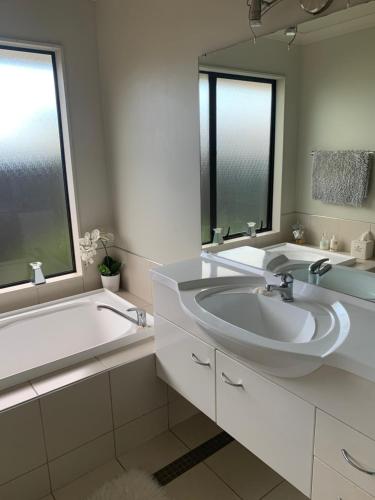 a bathroom with a sink and a tub and a mirror at Private Retreat in Cambridge