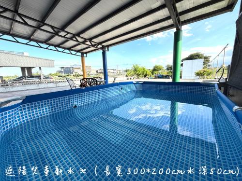 a swimming pool on the roof of a building at 晨溪民宿 in Wujie
