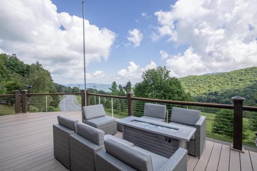 a patio with two chairs and a table on a deck at Eagles Nest on Seven Devils in Seven Devils