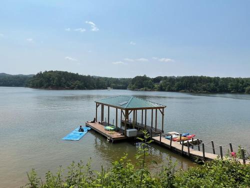 a dock with a gazebo in the middle of a lake at Lake Haven Lodge in Wilkesboro