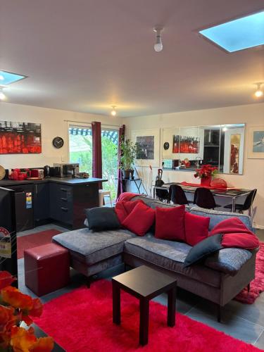 a living room with a couch and a kitchen at MOWA Art House Apartment in Huonville
