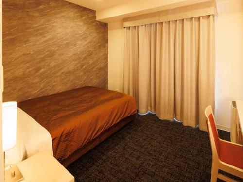 a hotel room with a bed and a window at J Hotel Rinku in Tokoname
