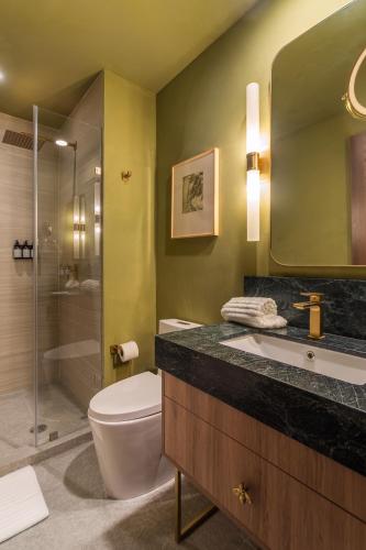 a bathroom with a toilet and a sink and a shower at Brada Collection Stays in Guadalajara