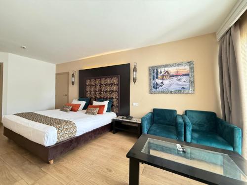 a hotel room with a bed and a couch and a table at HAMILTON Agadir in Agadir