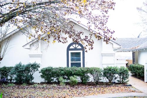 a white house with a tree at Golf Course Views, Sunsets & Chill Vibes in Columbus