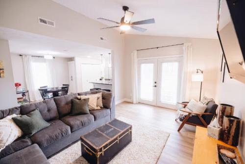 a living room with a couch and a table at Golf-Side Retreat Calm Central Stylish in Columbus