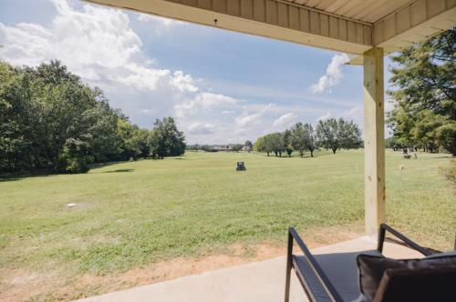 a porch with a view of a large field of grass at Golf-Side Retreat Calm Central Stylish in Columbus