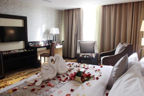a hotel room with two beds with flowers on them at National Park Hotel in Baljurashi