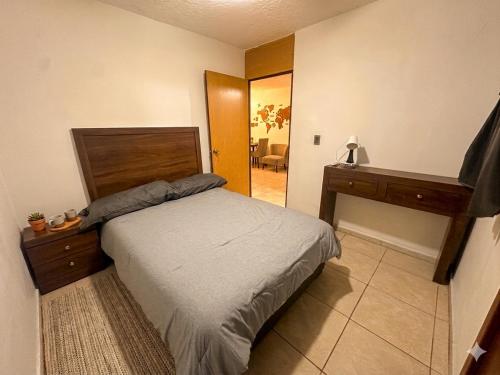 a bedroom with a bed and a dresser and a mirror at Casa Mezquite in Ocotlán