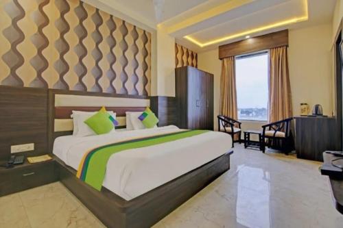 a bedroom with a bed and a desk in a room at Hotel Taj Venture Agra in Agra