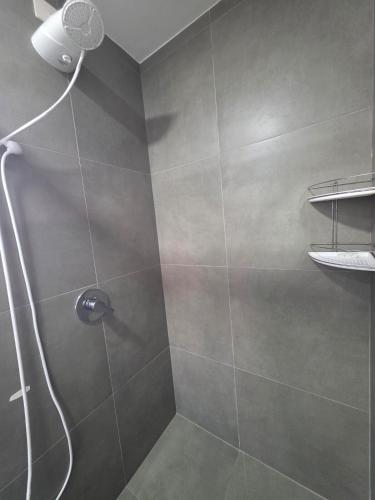 a shower with a shower head in a bathroom at Loft with pool and garage, next to Bourbon in Porto Alegre