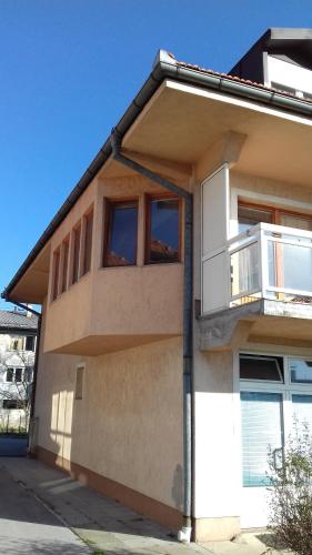 a house with a balcony on the side of it at Holiday Home Hodo in Sarajevo