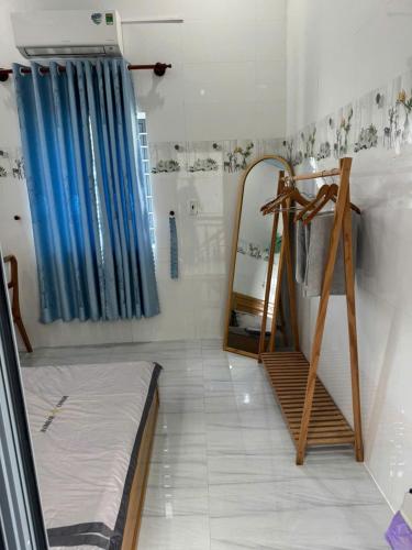 a room with a bed and a mirror and a ladder at KEN Homestay in Cu Lao Thu
