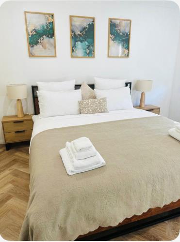 a bedroom with a large bed with two lamps at Resort-style living -pool in Bass Hill