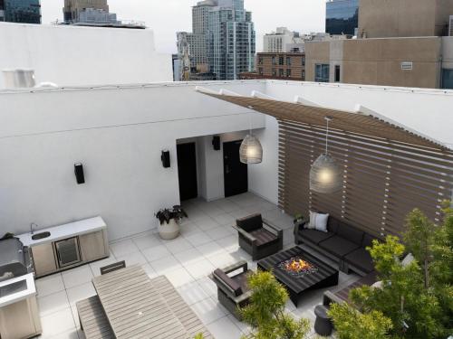 a rooftop patio with a fire pit on a building at The Margot Hotel San Diego Gaslamp Quarter, Outset by Hilton in San Diego