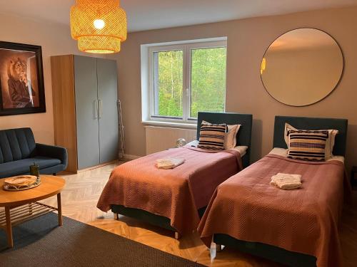 a living room with two beds and a mirror at Very large apartment with private sauna in Stężyca