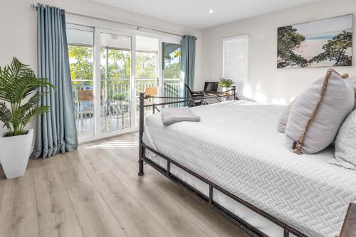 a bedroom with a bed and a balcony at Key Largo Kawama villa K1 in Key Largo