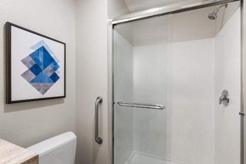 a bathroom with a shower with a glass door at Candlewood Suites Mobile-Downtown by IHG in Mobile