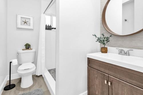 a bathroom with a toilet and a sink and a mirror at Key Largo Kawama villa K1 in Key Largo