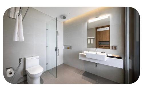 a bathroom with a toilet and a sink and a shower at 1404, Building 1, Ocean Sky Forest - Flamingo Cat Ba in Cat Ba