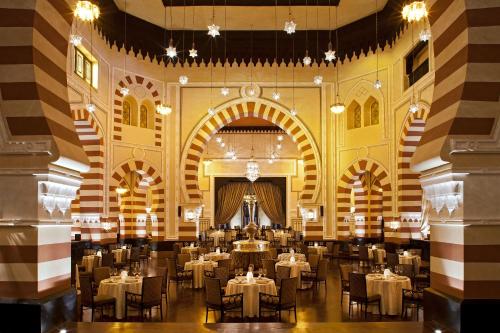 a dining room with tables and chairs in a building at Sofitel Legend Old Cataract in Aswan