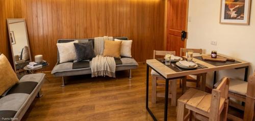 a living room with a couch and a table at Cabañas JP puerto montt in Puerto Montt