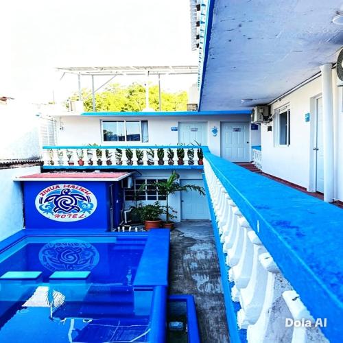 a view of the pool from the balcony of a house at Hotel Zihua Malibu in Zihuatanejo