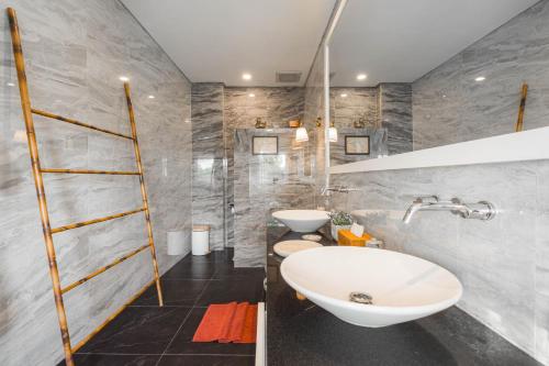 a bathroom with a sink and two toilets at The Magic Villa in Lebih